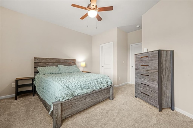 bedroom featuring a ceiling fan, baseboards, and light colored carpet