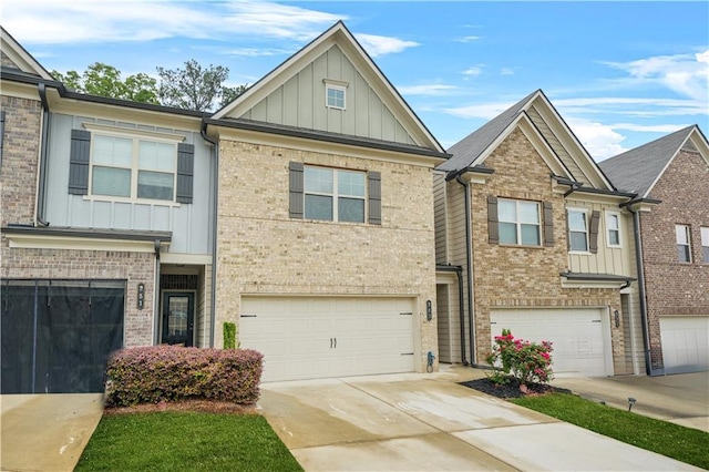 multi unit property featuring a garage, board and batten siding, concrete driveway, and brick siding