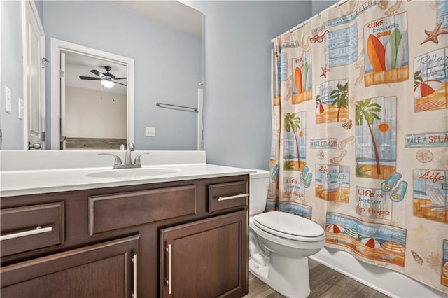 full bathroom featuring vanity, a ceiling fan, wood finished floors, and toilet