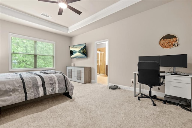 carpeted bedroom with ceiling fan, visible vents, baseboards, a raised ceiling, and ornamental molding