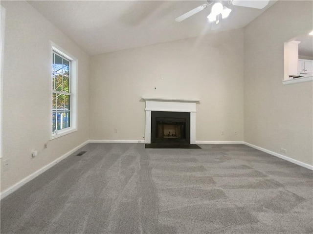 unfurnished living room featuring vaulted ceiling, ceiling fan, and carpet floors