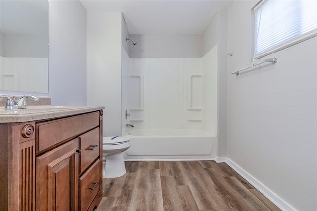 full bath featuring tub / shower combination, vanity, toilet, and wood finished floors