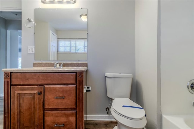 bathroom featuring shower / tub combination, vanity, toilet, and baseboards