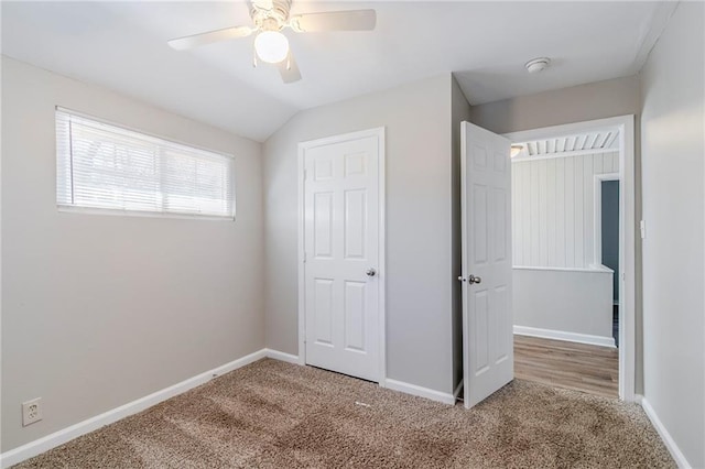 unfurnished bedroom featuring carpet, baseboards, and a ceiling fan