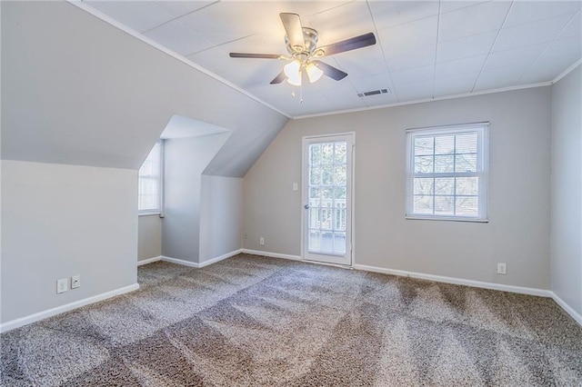 additional living space featuring a ceiling fan, baseboards, visible vents, and carpet flooring