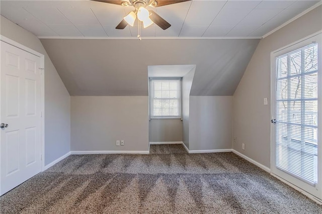 additional living space with lofted ceiling, ceiling fan, carpet, and baseboards