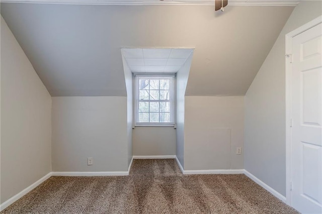 bonus room with lofted ceiling, baseboards, and carpet flooring