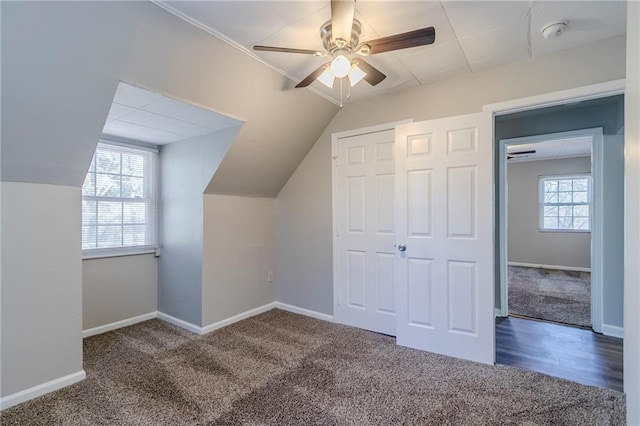 bonus room with carpet flooring, vaulted ceiling, baseboards, and ceiling fan