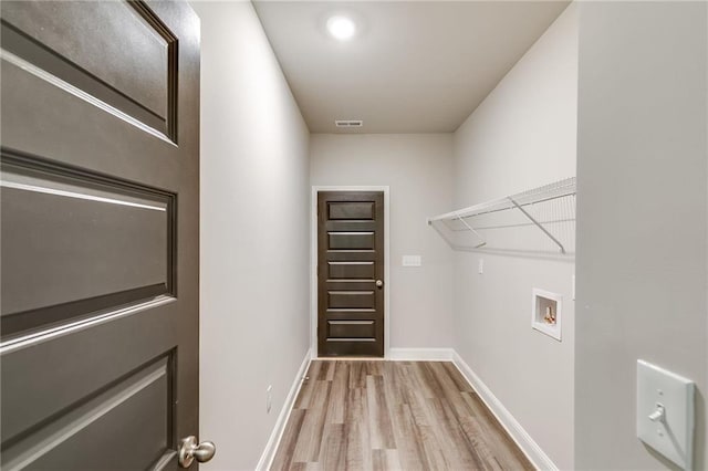 washroom featuring light hardwood / wood-style floors and hookup for a washing machine