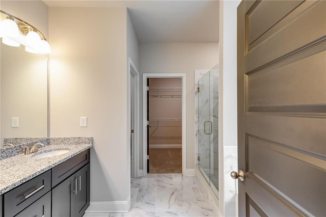 bathroom with vanity and a shower with door