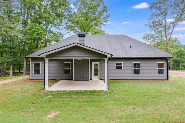 back of house with a yard and a patio area