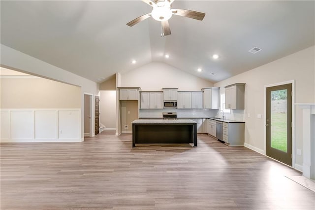 kitchen featuring gray cabinetry, ceiling fan, sink, stainless steel appliances, and a kitchen island