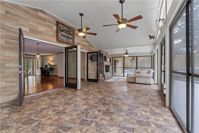 unfurnished sunroom with ceiling fan, french doors, a healthy amount of sunlight, and lofted ceiling