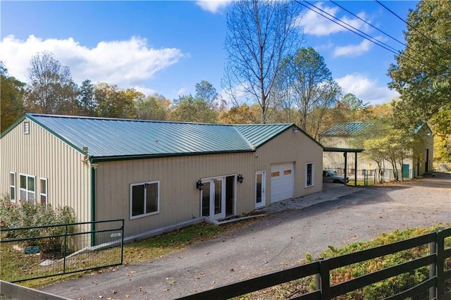 exterior space featuring french doors and a garage