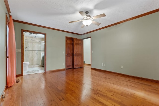 interior space featuring ensuite bathroom, light hardwood / wood-style flooring, ceiling fan, and crown molding