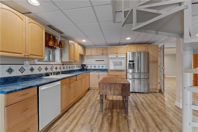 kitchen featuring sink, light wood-type flooring, stainless steel appliances, and light brown cabinetry