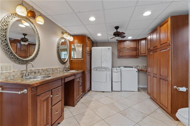 bathroom featuring tile patterned floors, washing machine and dryer, ceiling fan, and a paneled ceiling