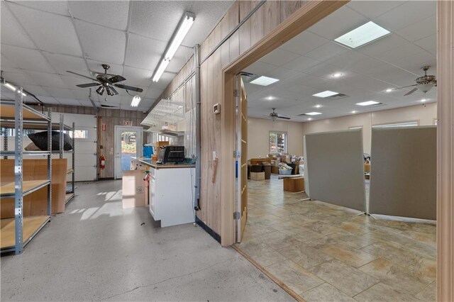 kitchen featuring a paneled ceiling and wooden walls