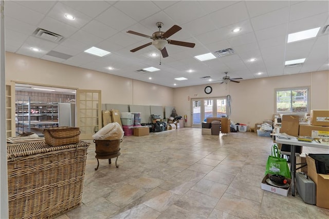 interior space featuring ceiling fan, french doors, and a drop ceiling