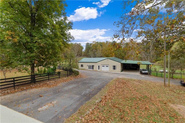 ranch-style house with a rural view and a carport