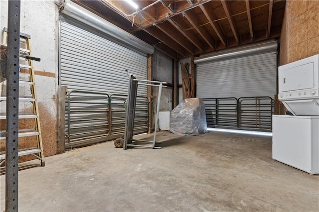 garage featuring stacked washer and dryer