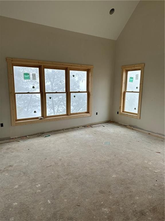 unfurnished room featuring high vaulted ceiling