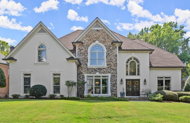 view of front of house with a front lawn and french doors