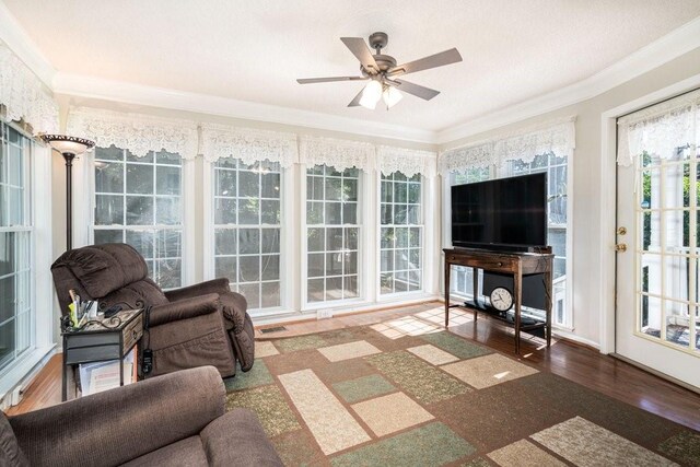 sunroom / solarium featuring ceiling fan