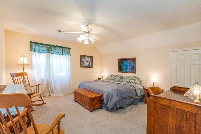 bedroom with ceiling fan, light carpet, and lofted ceiling