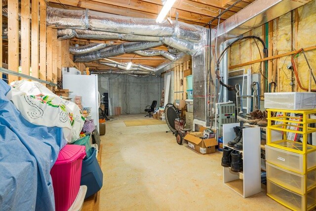 basement with white refrigerator