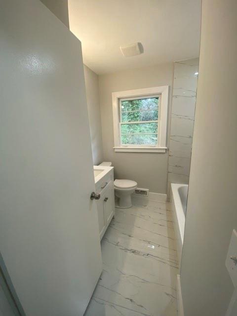 bathroom featuring walk in shower, toilet, a bathing tub, marble finish floor, and vanity