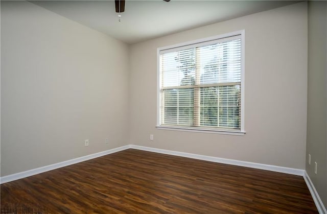 unfurnished room featuring dark wood-type flooring and ceiling fan