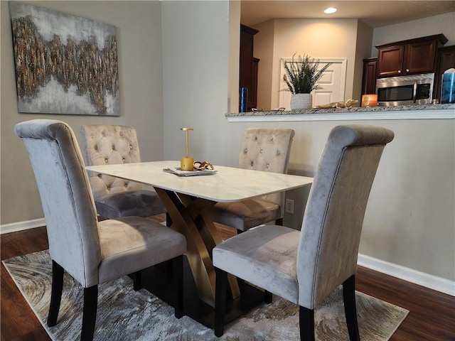 dining area with dark hardwood / wood-style floors