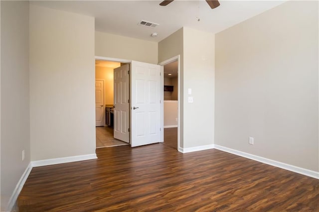 unfurnished bedroom featuring ceiling fan and dark hardwood / wood-style floors