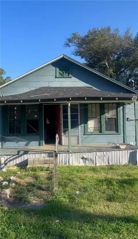 bungalow-style home with a porch and a front yard