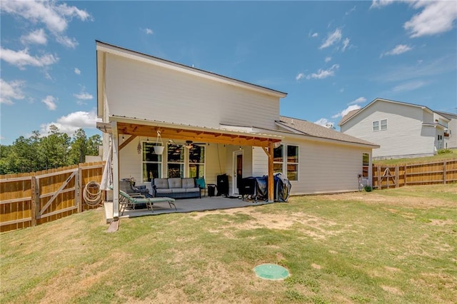 rear view of house featuring an outdoor hangout area, a patio, ceiling fan, and a lawn