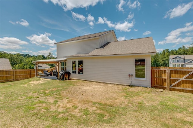 rear view of property featuring a patio and a lawn