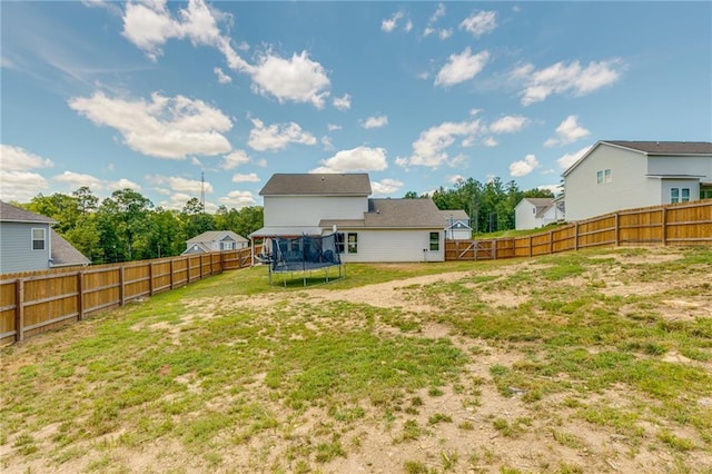 rear view of property featuring a trampoline