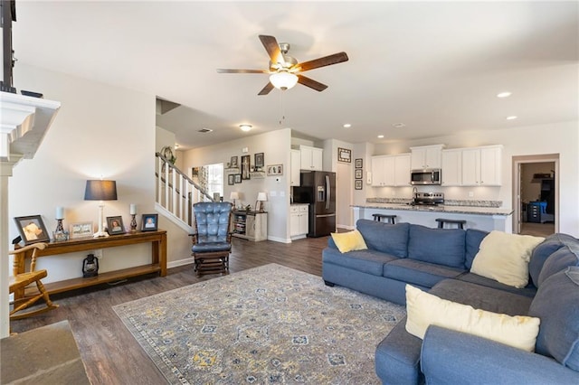 living room with ceiling fan and dark wood-type flooring