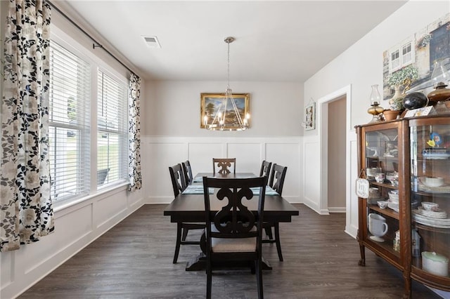 dining room with a chandelier and dark hardwood / wood-style floors