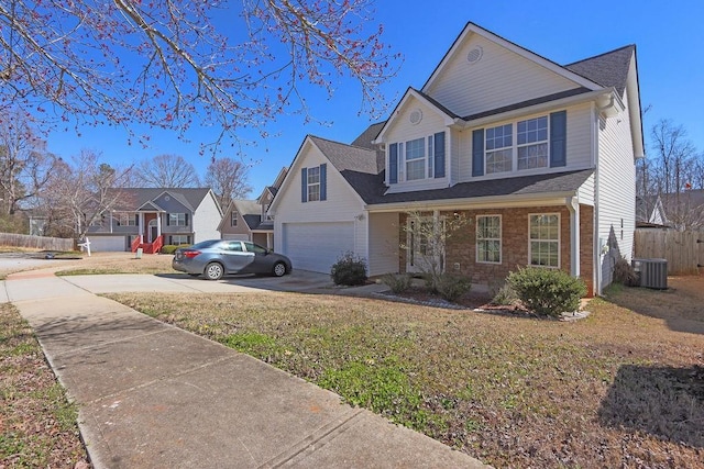 traditional home featuring an attached garage, cooling unit, brick siding, fence, and driveway