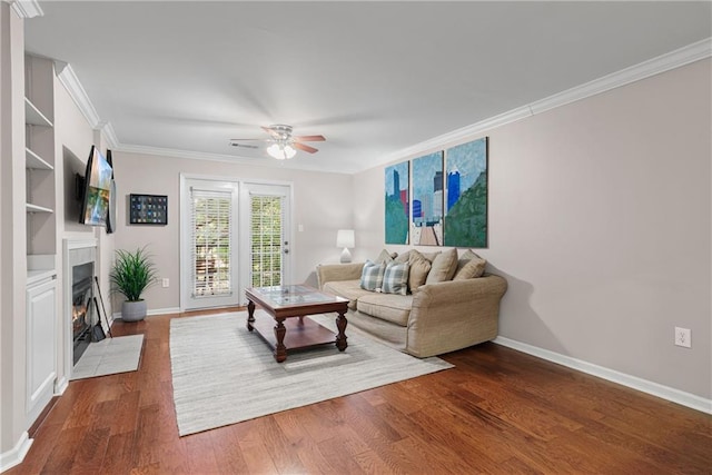 living room featuring ornamental molding, ceiling fan, and dark hardwood / wood-style flooring