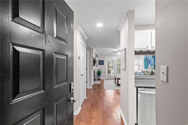 interior space with recessed lighting, baseboards, light wood-style floors, and ornamental molding