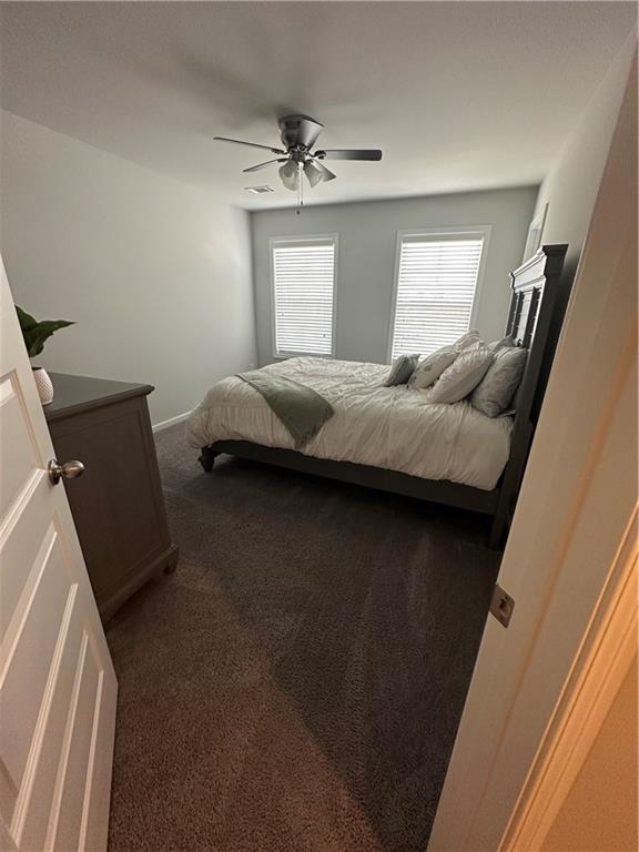 495 Sterling Creek Way, Loganville, GA 30052 - bedroom featuring dark colored carpet and a ceiling fan