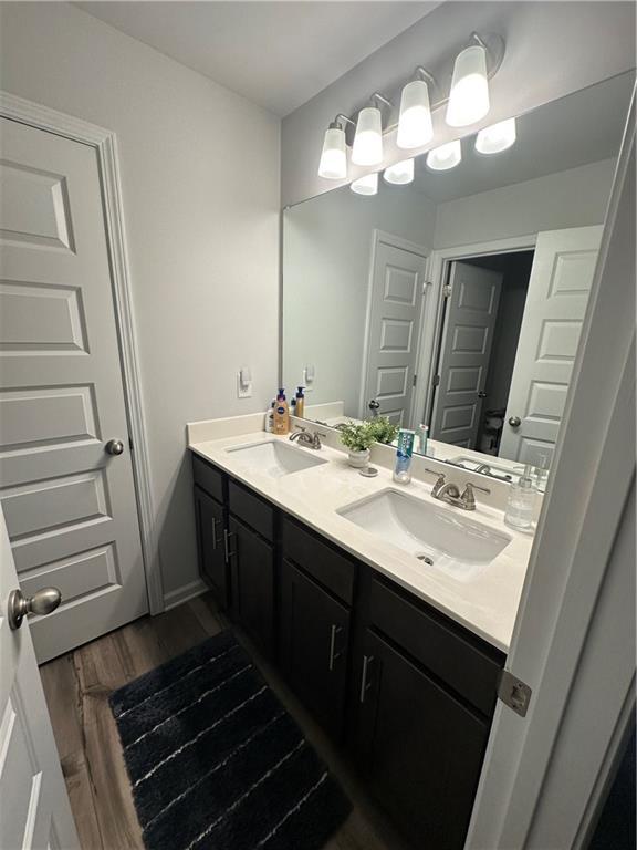 495 Sterling Creek Way, Loganville, GA 30052 - bedroom with dark colored carpet and a ceiling fan