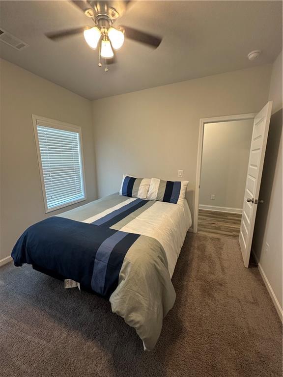 495 Sterling Creek Way, Loganville, GA 30052 - bedroom featuring dark carpet and a ceiling fan
