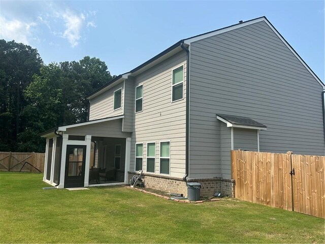 495 Sterling Creek Way, Loganville, GA 30052 - back of house with a fenced backyard, a sunroom, and brick siding