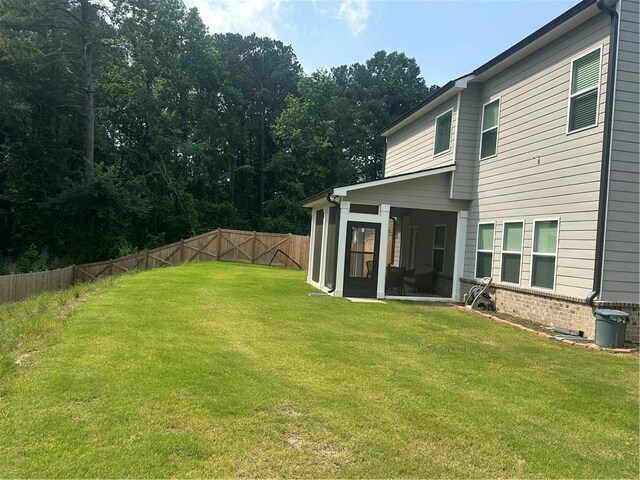 495 Sterling Creek Way, Loganville, GA 30052 - back of property with a sunroom and brick siding