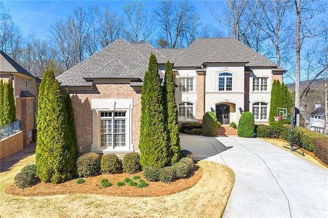 4080 Glen Hill Way NE, Marietta, GA 30066 - french country home with brick siding, a shingled roof, and concrete driveway