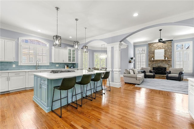 4080 Glen Hill Way NE, Marietta, GA 30066 - kitchen featuring ceiling fan, arched walkways, white cabinets, ornamental molding, and recessed lighting